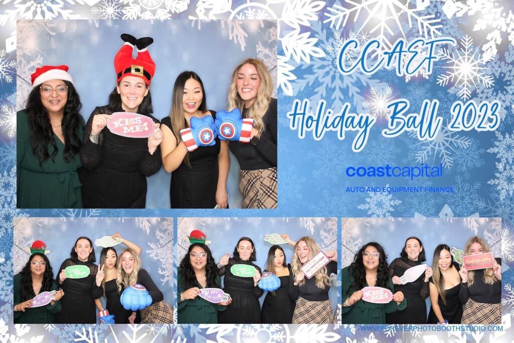 Friends using holiday props in front of a christmas photo booth backdrop